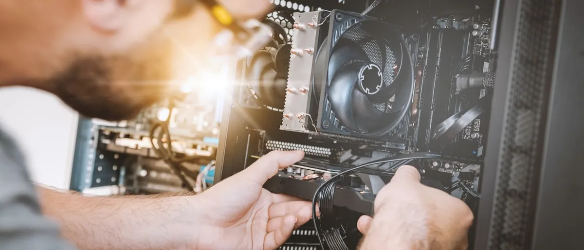 A technician working on the internal components of a desktop computer