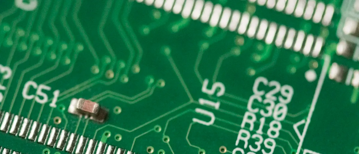 Extreme close-up of a green circuit board with visible components