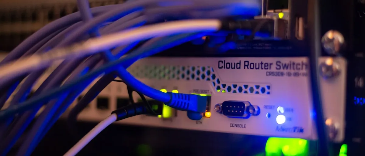 Close-up of network switch hardware with blue ethernet cables plugged in