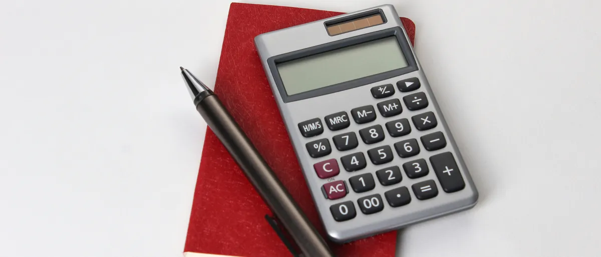 Financial balance sheet documents with a pen resting on top