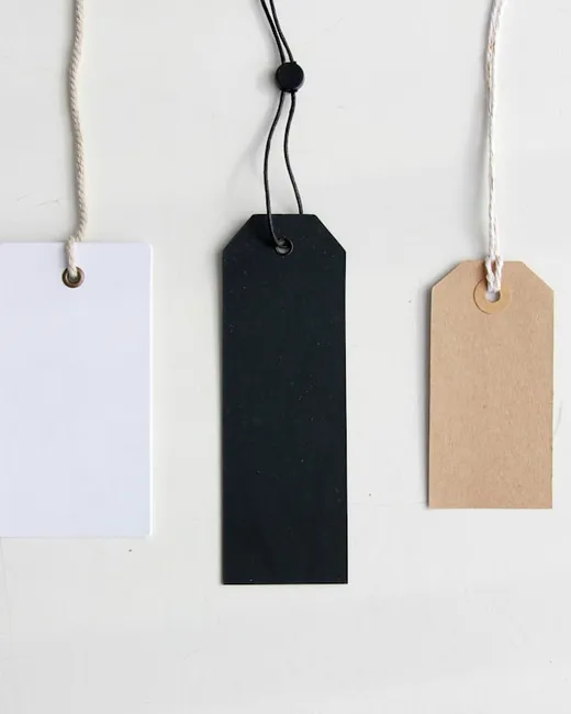 Three blank price tags hanging on strings
