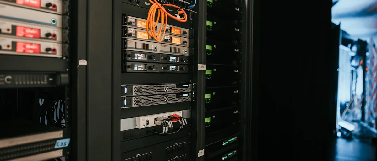 A close-up of a server rack with orange network cables